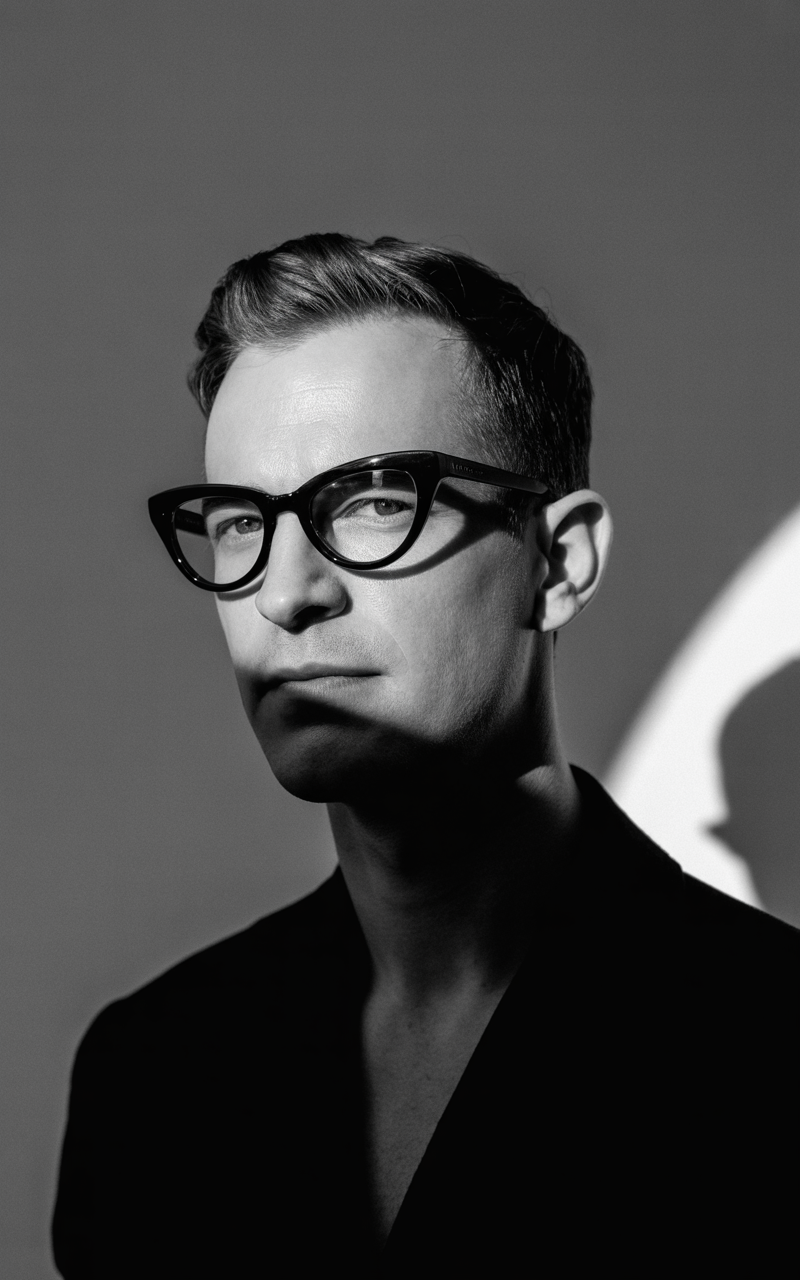 Close-up of a man wearing cat-eye glasses with confidence