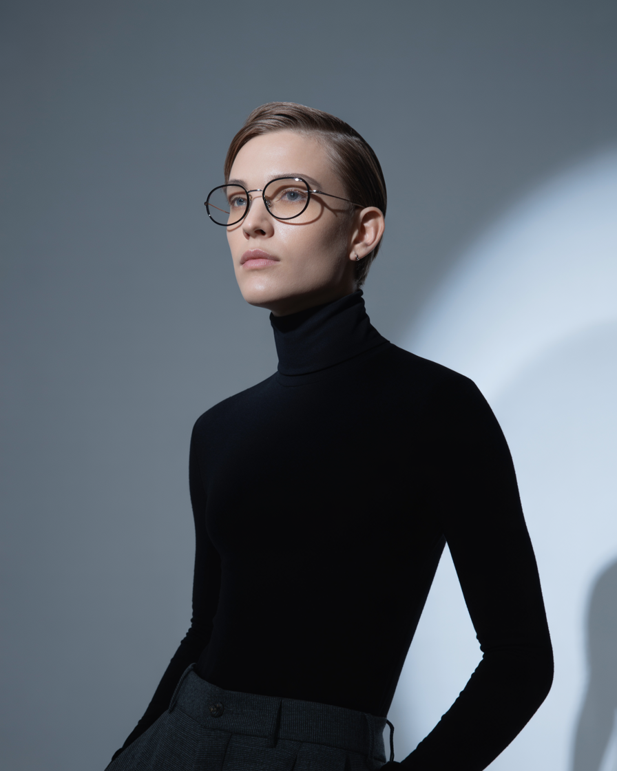 Unisex black oval glasses styled with a monochrome outfit