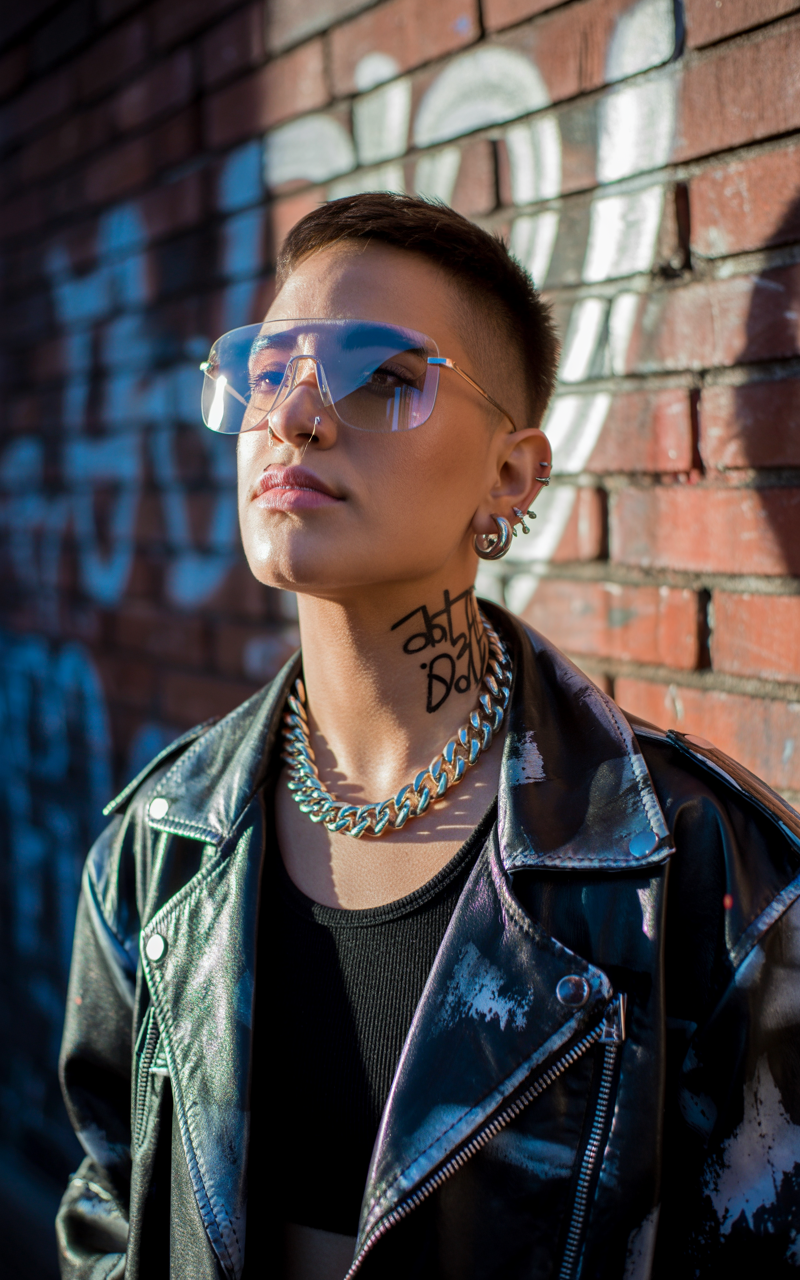 Unisex shield glasses styled with a leather jacket and bold accessories
