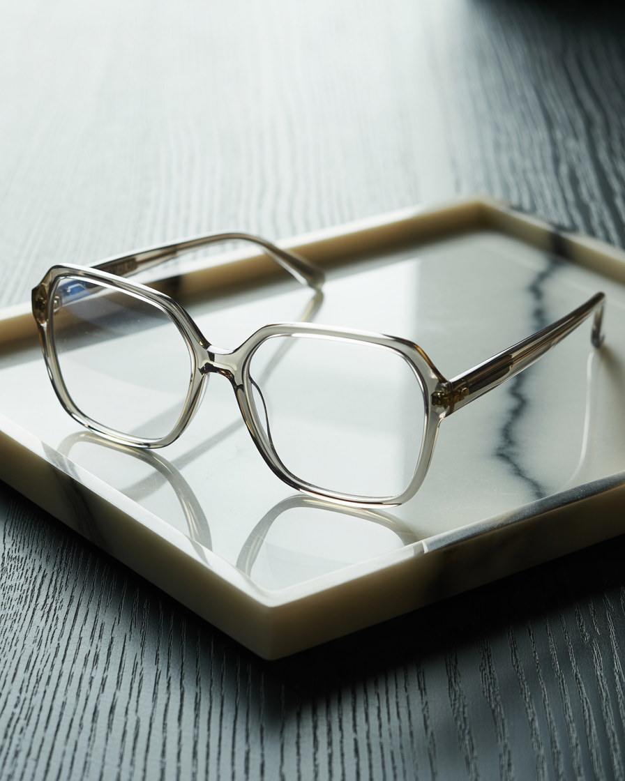 Oversized square acetate eyeglasses on a marble tray
